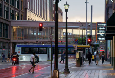 People walking in downtown Minneapolis as a Metro Transit bus moves down Nicollet Mall.