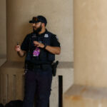 A Metropolitan Police Department officer smokes a cigar during the 2024 Republican National Convention in Milwaukee.