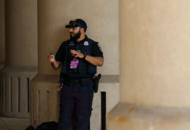 A Metropolitan Police Department officer smokes a cigar during the 2024 Republican National Convention in Milwaukee.