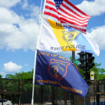 New Jersey State Police and New Jersey Department of Corrections flags flying at a security checkpoint at the 2024 Republican National Convention in Milwaukee.