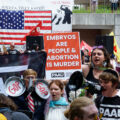 Protesters from Progressive Anti-Abortion Uprising meet other protesters that marched around the 2024 Republican National Convention in Milwaukee.