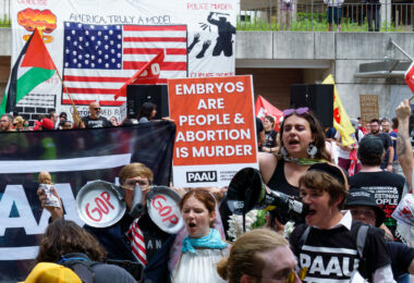 Protesters from Progressive Anti-Abortion Uprising meet other protesters that marched around the 2024 Republican National Convention in Milwaukee.