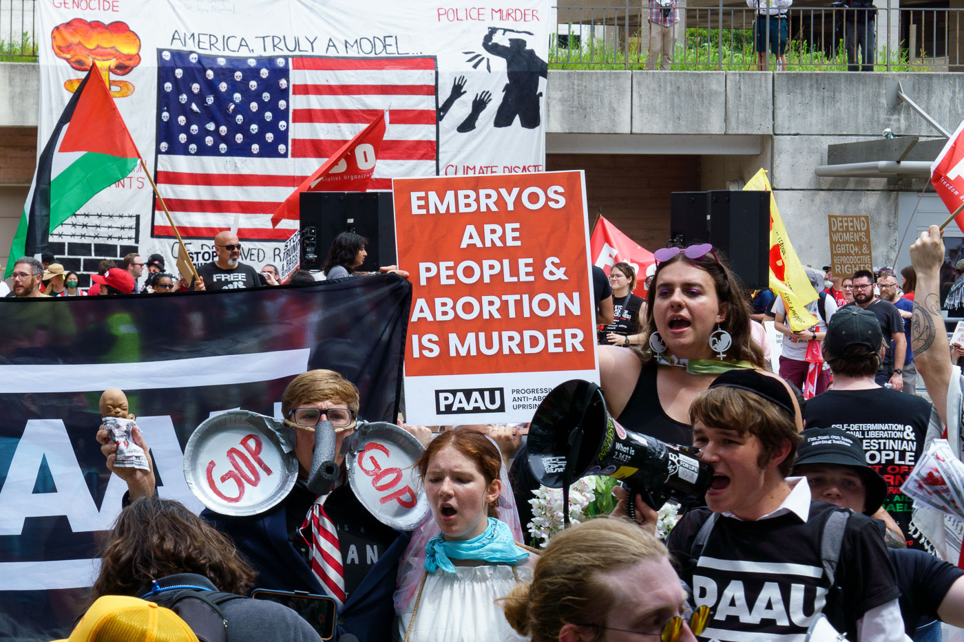 Protesters from Progressive Anti-Abortion Uprising meet other protesters that marched around the 2024 Republican National Convention in Milwaukee.