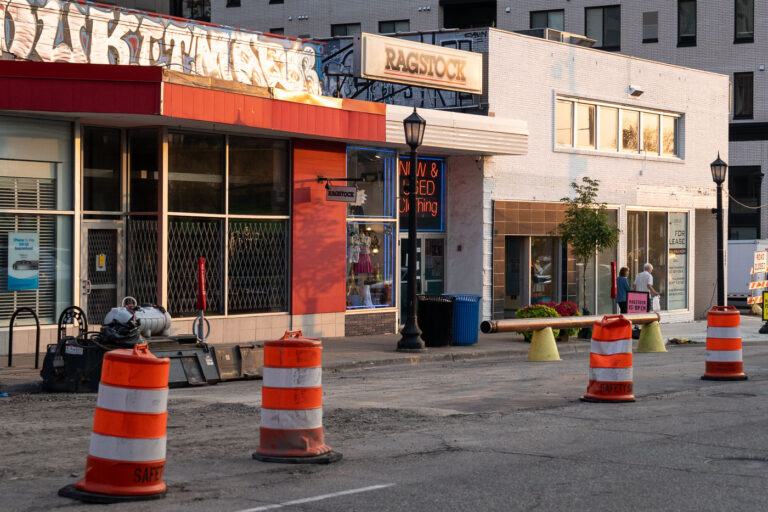 Ragstock Graffiti 2 Graffiti above Ragstock. An older couple walk down the under construction Lake Street.