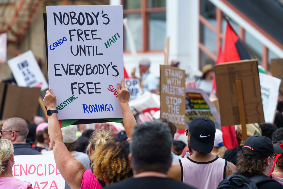 Protester holding up a sign that reads "Nobody's Free Until Everybody's Free" at a march during the 2024 Republican National Convention.