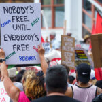 Protester holding up a sign that reads "Nobody's Free Until Everybody's Free" at a march during the 2024 Republican National Convention.