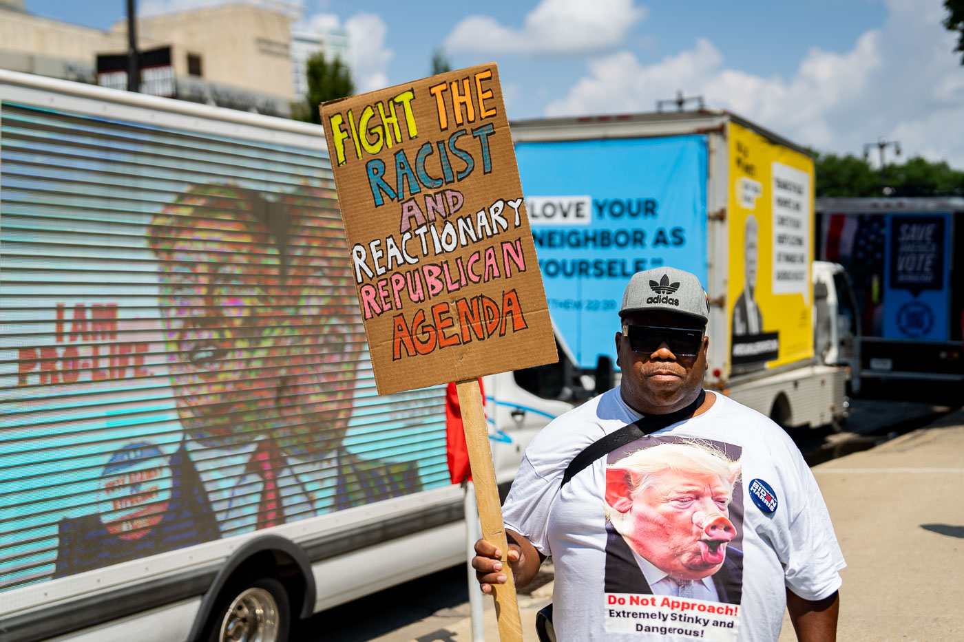 Anthony Johnson holds up a sign that reads "Fight the racist and reactionary republican agenda" outside the 2024 Republican National Convention in Milwaukee.