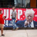 RNC 2024 Trump Supporter on megaphone outside a Republican National Convention checkpoint.