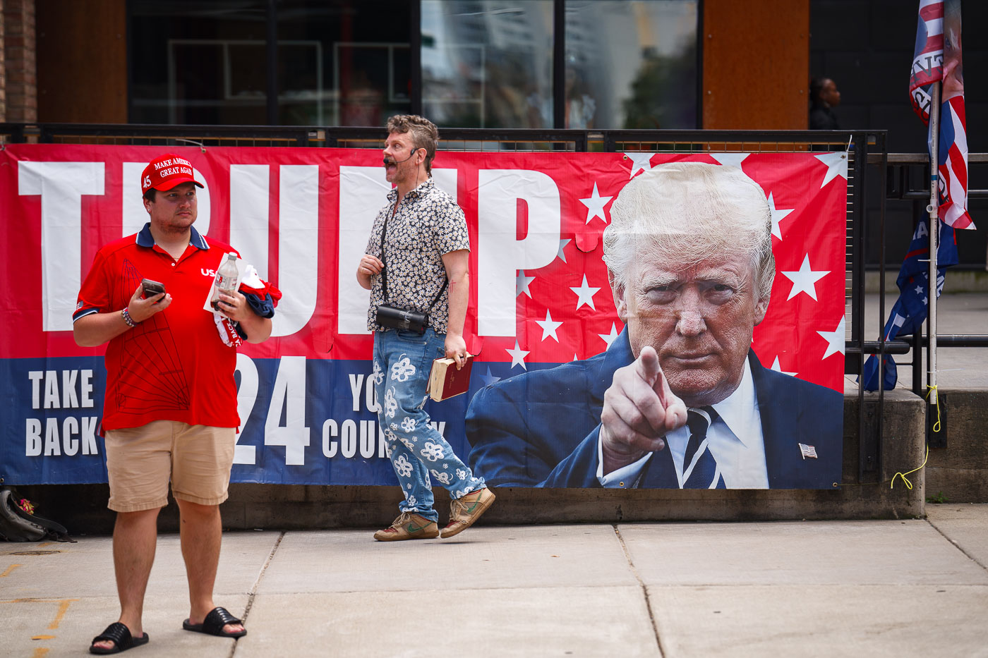 RNC 2024 Trump Supporter on megaphone outside a Republican National Convention checkpoint.