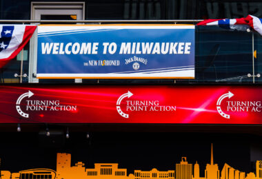 Welcome to Milwaukee and Turning Point Action signage across from the Fiserv Forum. The forum is hosting the 2024 Republican National Convention.