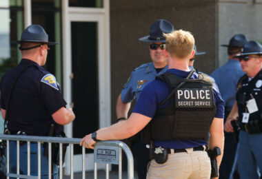 A Secret Service officer speaks to local law enforcement officers at the secure perimeter of the 2024 Republican National Convention in Milwaukee.