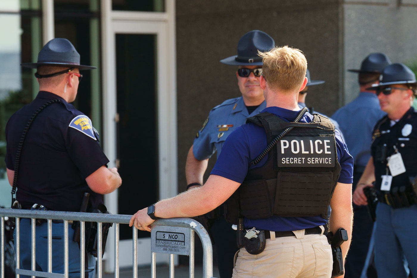 A Secret Service officer speaks to local law enforcement officers at the secure perimeter of the 2024 Republican National Convention in Milwaukee.