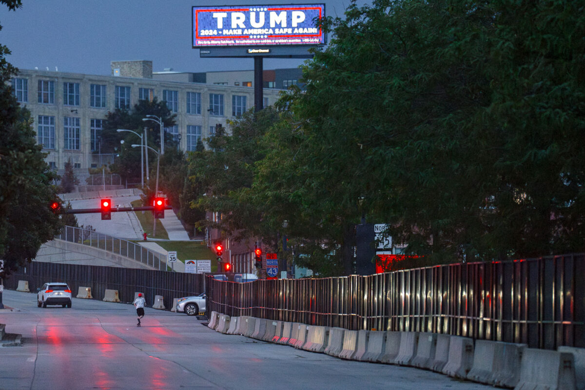 A Trump billboard outside the RNC security fencing hours after an assassination attempt in Pennsylvania.