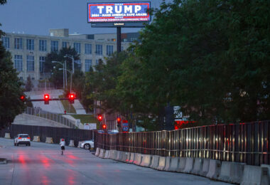 A Trump billboard outside the RNC security fencing hours after an assassination attempt in Pennsylvania.