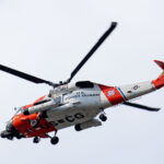 A United States Coast Guard helicopter flying over the 2024 Republican National Convention in Milwaukee.