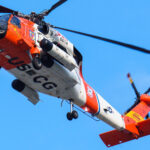 A United States Coast Guard helicopter flies over the Summerfest grounds in Milwaukee where a RNC welcome party is taking place.
