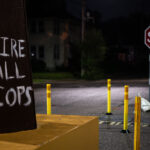 "Fire All Cops" written on a fist at George Floyd Square in South Minneapolis.