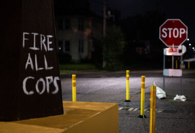 "Fire All Cops" written on a fist at George Floyd Square in South Minneapolis.