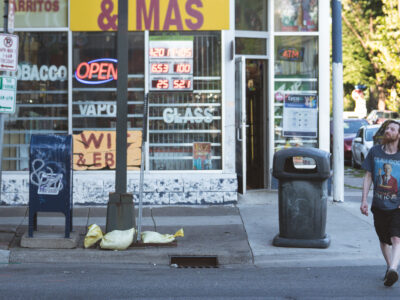 Man walks past store on Nicollet Ave, Minneapolis