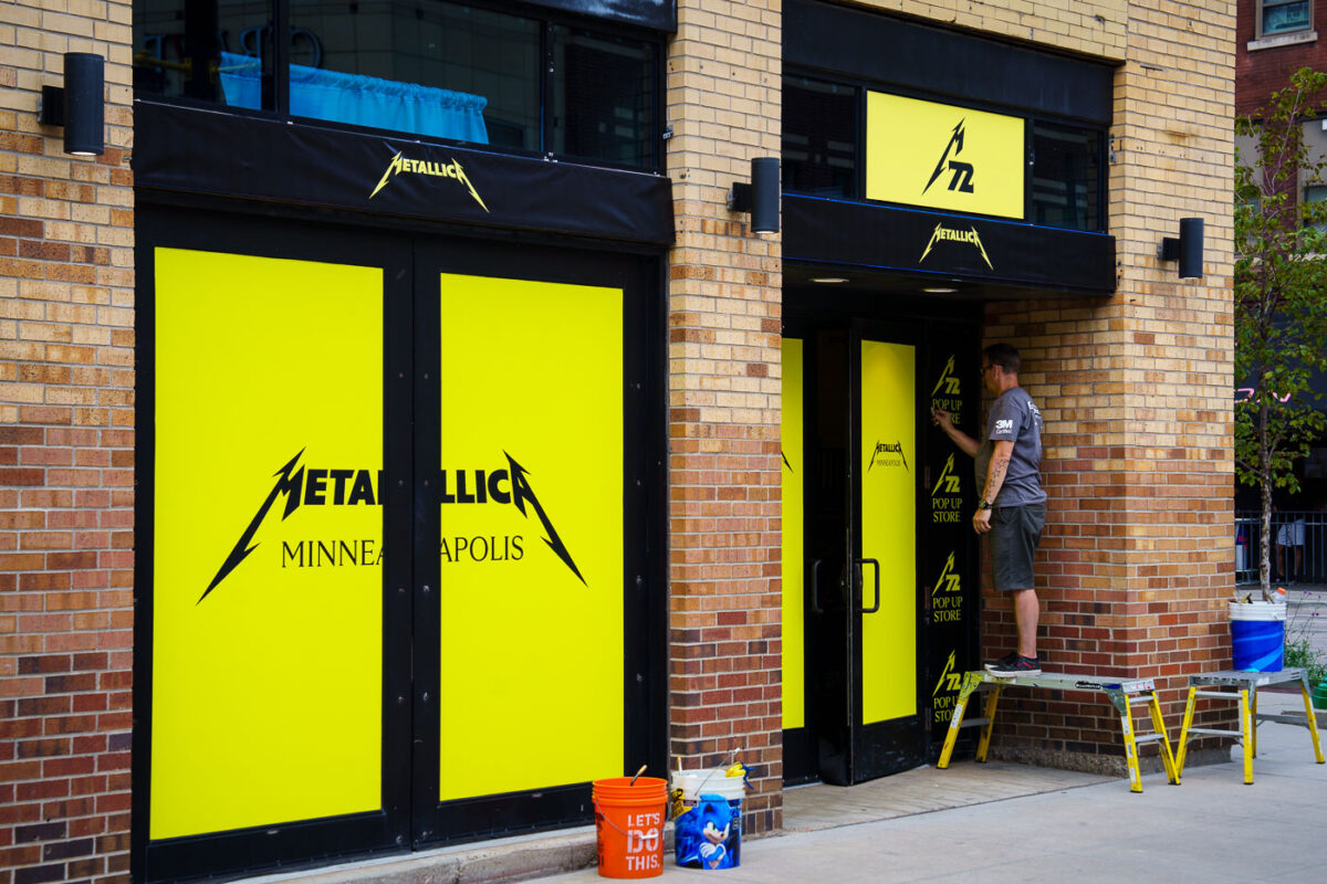 Window wrap going up on Hennepin Ave for a Metallica pop-up store. The band headlines two nights at US Bank Stadium this weekend.