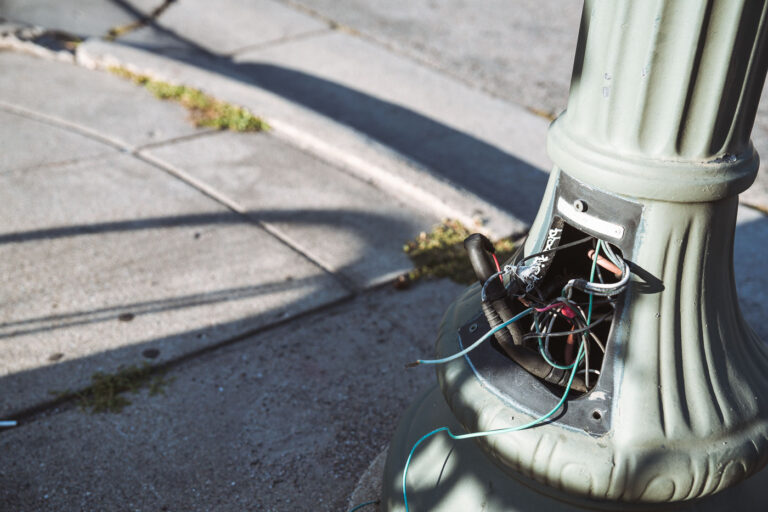 Streetlight Wiring Stripped by Copper Thieves in Minneapolis 1 A light pole near a city intersection in Minneapolis shows exposed and stripped wiring — the result of ongoing copper theft that has plagued the city’s infrastructure in recent years. Thieves pry open the access panels at the base of streetlights to remove the copper cabling inside, often leaving entire blocks without functioning lights.Copper’s rising market value has made it a frequent target for theft across Minneapolis, affecting not only street lighting but also traffic signals, HVAC systems, and even public art installations. City crews routinely repair these damages, but replacement costs can reach hundreds of thousands of dollars annually. Officials have experimented with deterrents such as tamper-proof covers and non-copper wiring, yet the problem persists, reflecting a broader challenge faced by municipalities nationwide.
