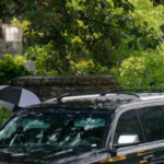 Minnesota Governor Tim Walz and family leave his Eastcliff residence under heavy rain. There is "Reception with Tim Walz" "Harris Victory Fund" event near downtown Minneapolis tonight.