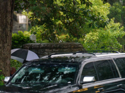 Tim Walz Departs Eastcliff Residence in Rain for Fundraiser