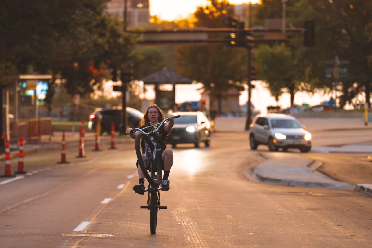 Biker on Lake Street in Minneapolis also enjoying the last day of summer - on one wheel.