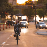 Biker on Lake Street in Minneapolis also enjoying the last day of summer - on one wheel.