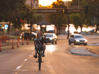 Biker performs wheelie on Lake Street, Minneapolis