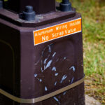 After light poles continue to be damaged by copper thieves, new LED lighting on a popular Minneapolis trail comes with a new reflective sign: "Aluminum Wiring Inside No Scrap Value".