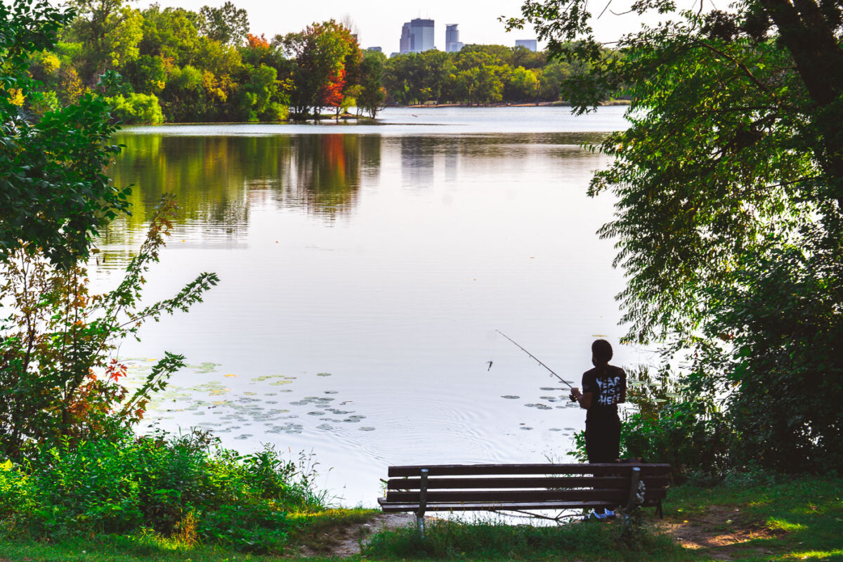 A fisherman casts a rod into Cedar Lake in Minneapolis on September 11, 2024.