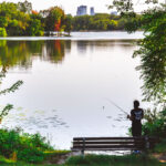 A fisherman casts a rod into Cedar Lake in Minneapolis on September 11, 2024.