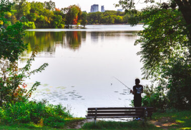 A fisherman casts a rod into Cedar Lake in Minneapolis on September 11, 2024.