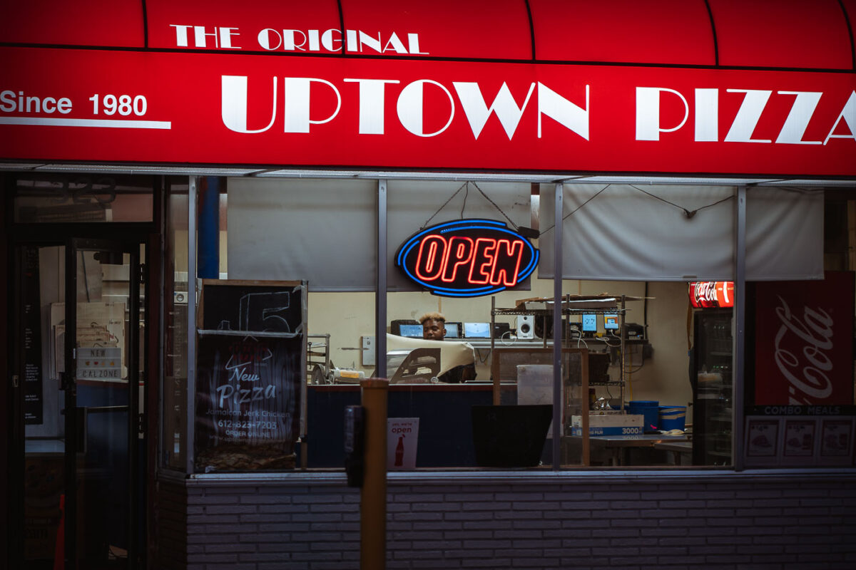 Man flips pizza dough at Uptown Pizza on Lake Street in Minneapolis.