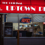 Man flips pizza dough at Uptown Pizza on Lake Street in Minneapolis.