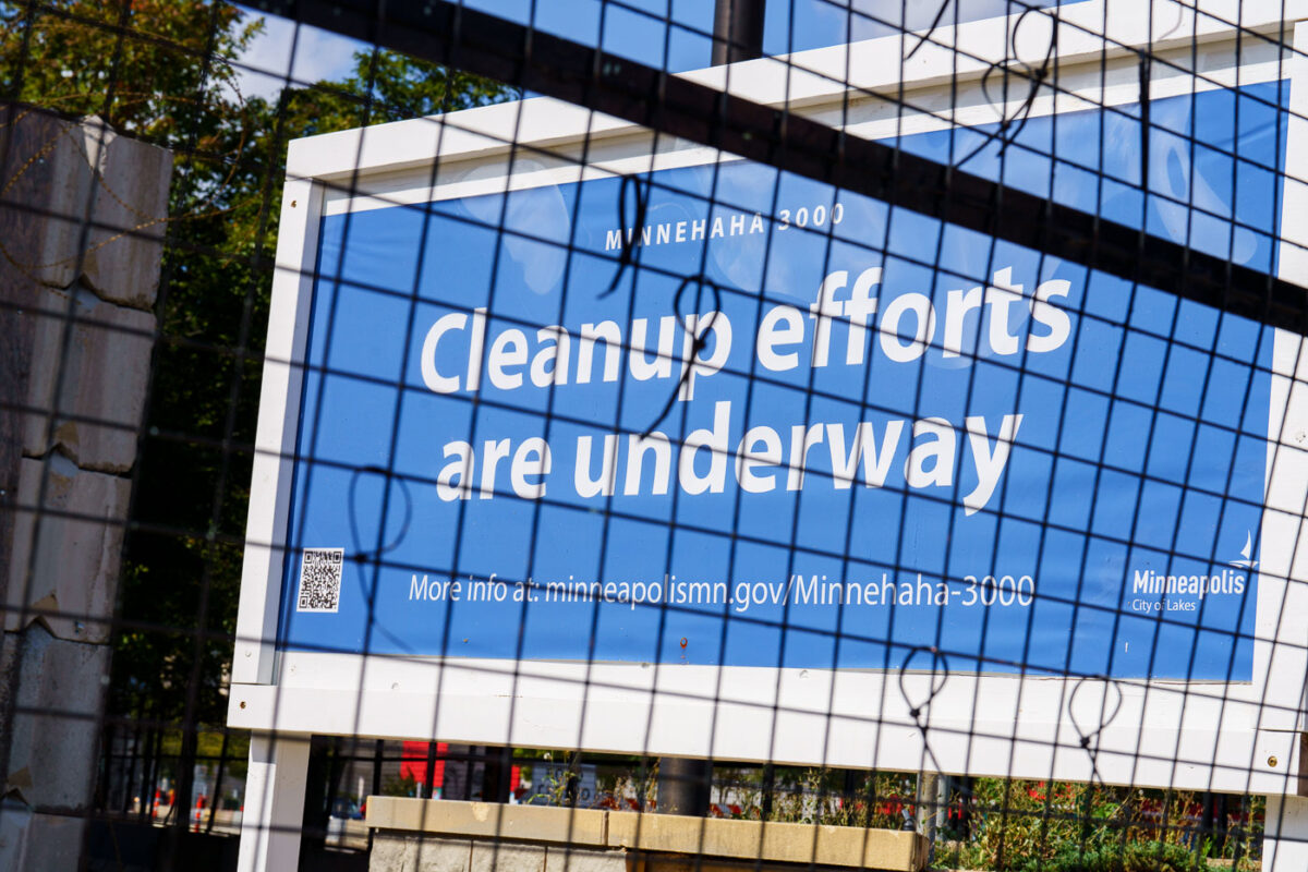 Signage at the former Minneapolis police third precinct police station proclaiming cleanup efforts underway. The building is being renovated into a voting center.