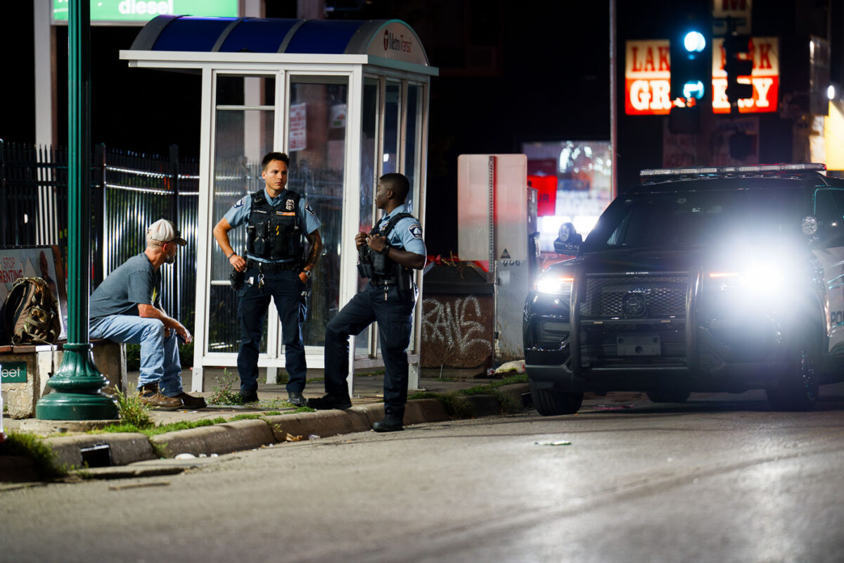 Minneapolis police speak to a man on Lake Street in South Minneapolis.