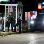 Minneapolis police speak to a man on Lake Street in South Minneapolis.