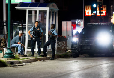 Minneapolis police speak to a man on Lake Street in South Minneapolis.