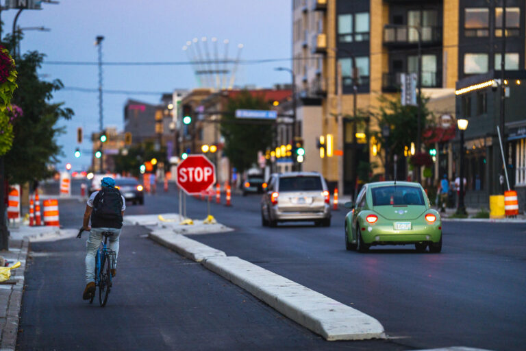 New Bike Lane Riding 2 A biker on a brand new bike lane on Lake Street in Uptown Minneapolis.