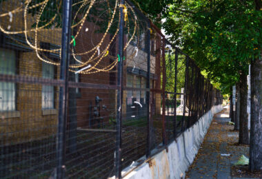 Razor wire and concrete barricades continue to surround the former Minneapolis police 3rd precinct police station. The station was burned by protesters in May 2020 and is being renovated into an community voting center.