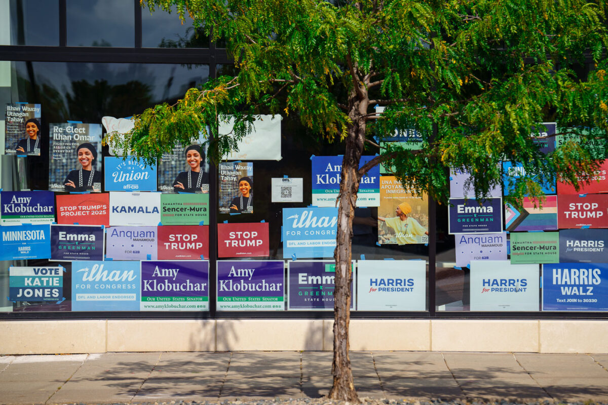 Kamala Harris, Tim Walz, Ilhan Omar, Amy Klobuchar yard signs in the windows of the Minneapolis DFL office.