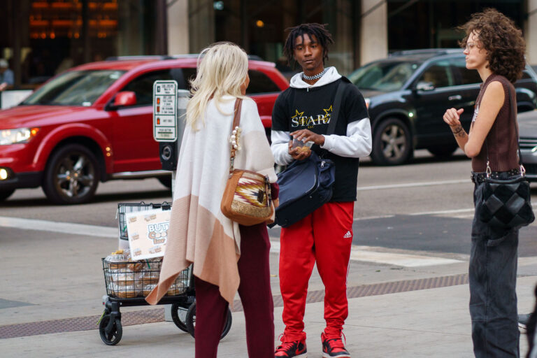 Downtown Minneapolis Street Vendor Selling Butter Cookies 3 A street vendor, identified by the "Butter Cookies For Days" sign on their cart, operates in downtown Minneapolis. The vendor is interacting with customers amidst urban traffic, with vehicles and buildings forming the backdrop. Street vending is a common practice in urban environments, providing goods and services directly to pedestrians and contributing to the city's commercial activity. This image captures a moment of everyday commerce within the downtown district, a hub for business and public life in Minneapolis.