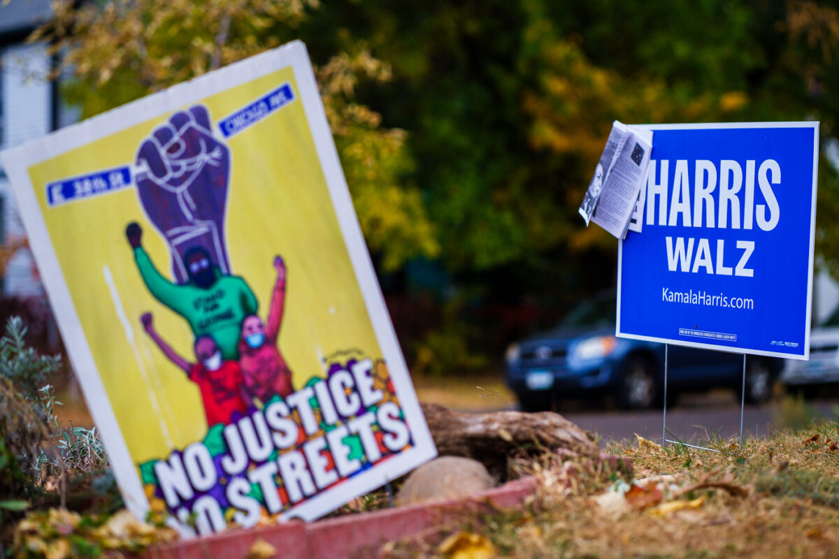 Kamala Harris Tim Walz for President sign next to a "No Justice No Streets" George Floyd Square sign in South Minneapolis.