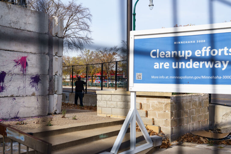 Minneapolis 3rd Precinct: Razor Wire Removal and Redevelopment 1 Workers remove razor wire from the Minneapolis Police Department's Third Precinct building, which was damaged during protests following the murder of George Floyd in 2020. The precinct was subsequently fortified with concrete barricades and razor wire. The city is now redeveloping the site into a "Democracy Center" intended to house election services and community spaces, replacing the temporary security measures with standard construction fencing.