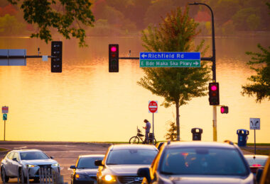Biker stops in front of Bde Maka Ska in South Minneapolis. As seen from 36th Street.