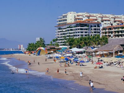Beachgoers and Palapa Umbrellas at Playa de los Muertos