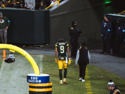 Christian Watson Heads to the Sideline at Lambeau Field