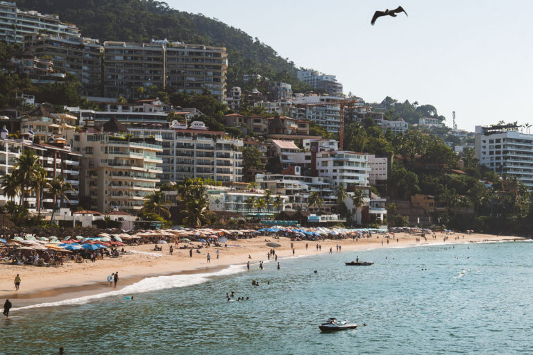 Playa de los Muertos and Zona Romántica, Puerto Vallarta, Mexico 1 Playa de los Muertos, a popular beach in Puerto Vallarta's Zona Romántica, is a central hub for local life and tourism. The pier, a prominent feature extending into the Pacific Ocean, serves as a vital access point for water taxis and a gathering place for visitors and residents. The surrounding Zona Romántica, known for its vibrant atmosphere and diverse businesses, has seen significant development, transforming from a quieter area into a bustling district that attracts international visitors. The beach and its pier are integral to the identity and economy of Puerto Vallarta, reflecting its growth as a major Mexican resort destination.
